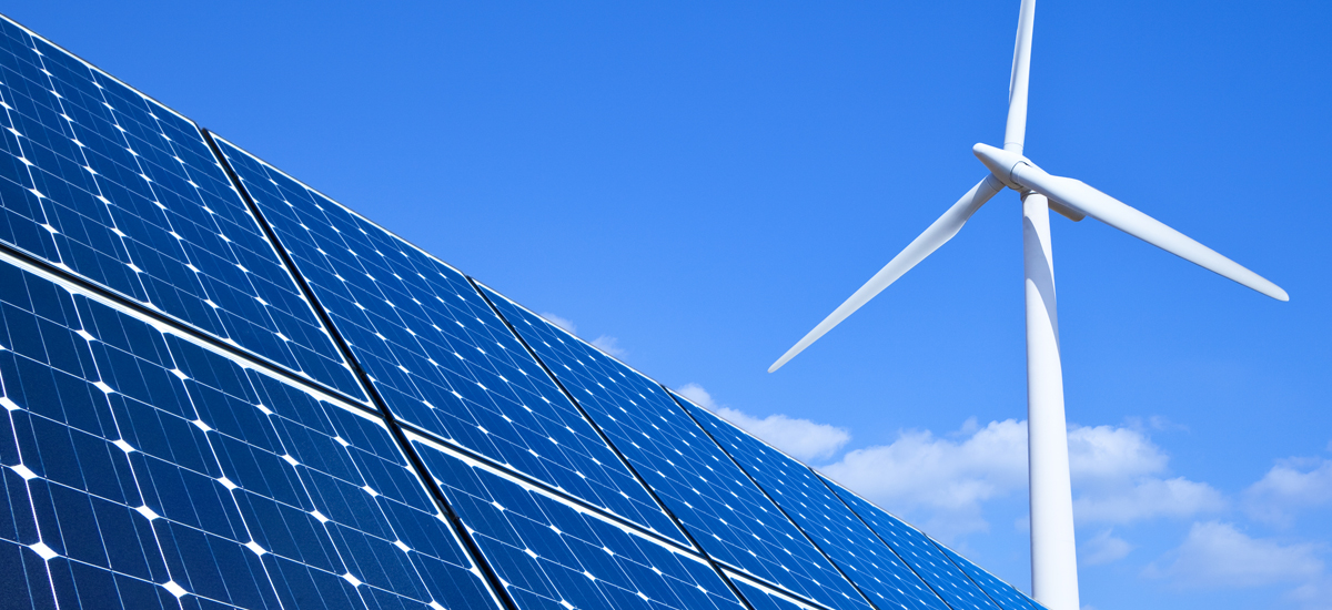 sustainability image of solar panels and wind turbine